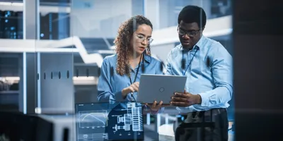 Lab scientists discussing service contracts over a laptop