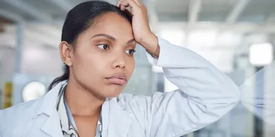 Lab worker demonstrating signs of burnout in a lab setting