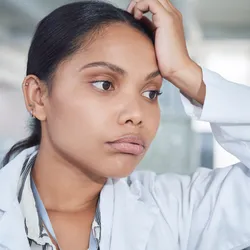 Lab worker demonstrating signs of burnout in a lab setting