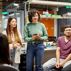 Lab manager leading a discussion with students in a laboratory setting.