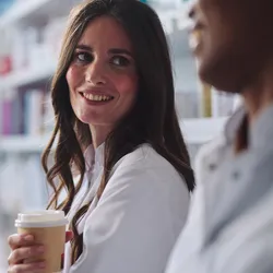 Two lab colleagues sharing a moment over coffee