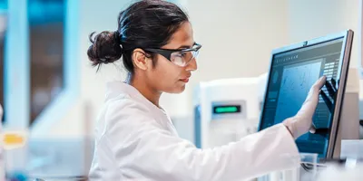 Researcher analyzing data for artificial intelligence in protein engineering
