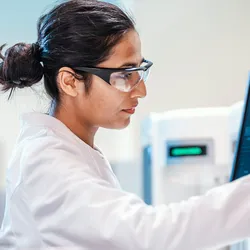 Researcher analyzing data for artificial intelligence in protein engineering