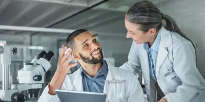 Lab manager and worker engaging in conversation about technology