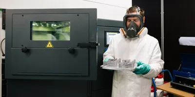 Researcher overseeing metal 3D printing process