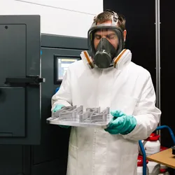 Researcher overseeing metal 3D printing process