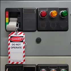 Lockout/tagout device attached to equipment control panel