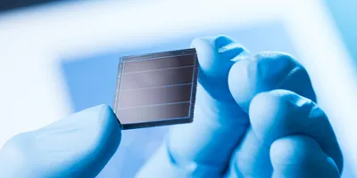 Scientist examining a solar cell related to solar fuel technology.