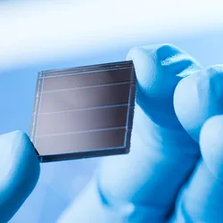 Scientist examining a solar cell related to solar fuel technology.