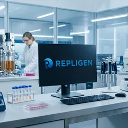 a modern biotech lab with a computer monitor on the lab bench displaying the Repligen logo