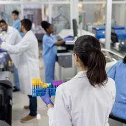 Group of scientists working at the laboratory processing blood samples