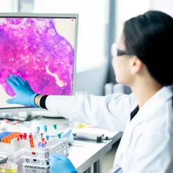 Medical professionals reviewing digital pathology on a screen