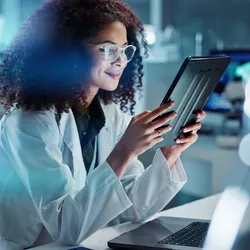 Motivated lab employee working on a tablet