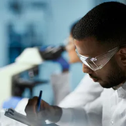 Researcher analyzing laboratory data on a digital screen.