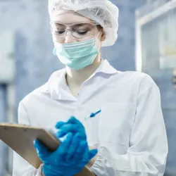 Laboratory worker reviewing safety protocols