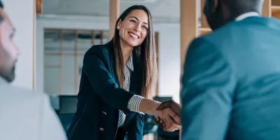Female business leader shaking hands with potential candidate.
