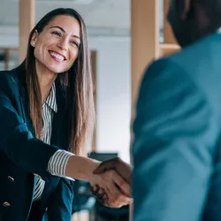 Female business leader shaking hands with potential candidate.
