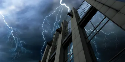 Lightning striking a building creating a power outage or blackout