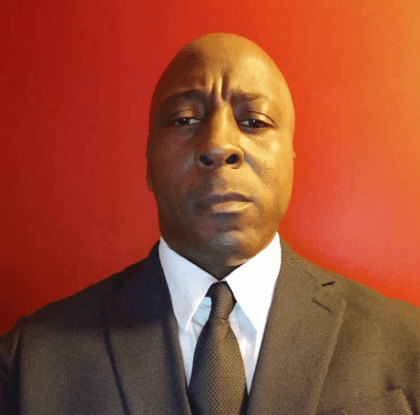 Professional in a suit against a red background