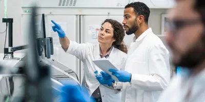 Researchers in lab explore scaling operations together.
