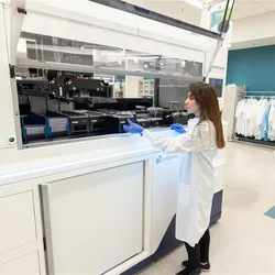 Female researcher using the The CellXpress.ai Automated Cell Culture System in the lab
