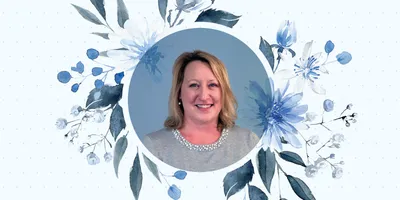 Portrait headshot of Alyssa Moore with blue flowers surrounding it