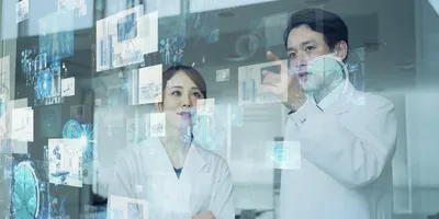 Two lab researchers discuss AI data.