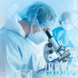Scientist examining DNA samples with a microscope in a lab setting