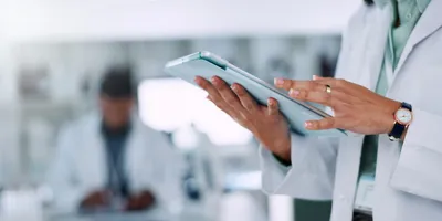 Scientist using a tablet for LIMS customization in a laboratory