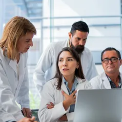 Laboratory personnel collaborating on compliance and quality practices
