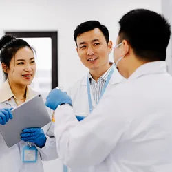 Colleagues discussing lab safety and peer lab inspections