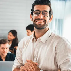 Agile leader standing in front, with his team working independently behind him.