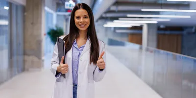 Lab staff member smiles and shows thumbs up to represent employee recognition programs