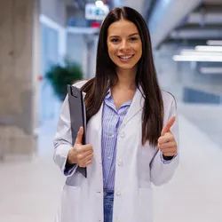 Lab staff member smiles and shows thumbs up to represent employee recognition programs