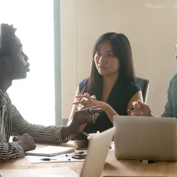 Multiethnic millennial colleagues dispute and talk through their thoughts on a project launch in office