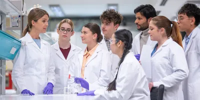 A team in a laboratory discussing error reporting and psychological safety