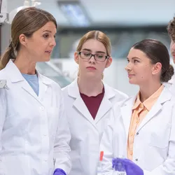 A team in a laboratory discussing error reporting and psychological safety