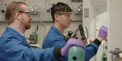 Researchers working on electrochemical carbon capture in a laboratory