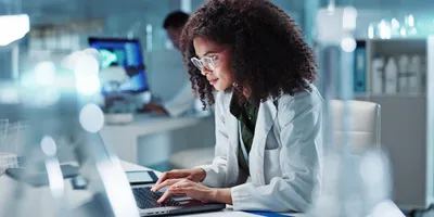woman on laptop in bioanalysis lab