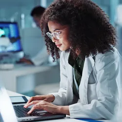 woman on laptop in bioanalysis lab