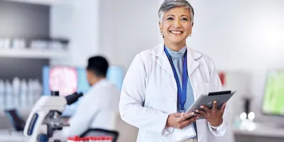 Laboratory manager in a lab coat with a tablet