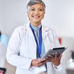 Laboratory manager in a lab coat with a tablet