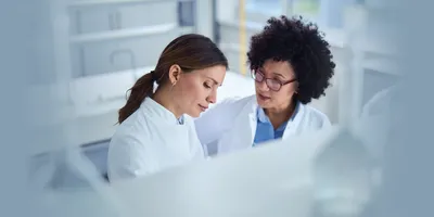 Two female scientists collaborating in the lab