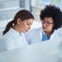 Two female scientists collaborating in the lab