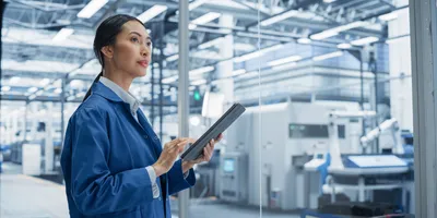 Focused Asian Engineer Monitoring and Analyzing Conditions in a laboratory on Tablet Device