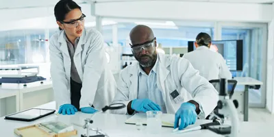 Lab manager and colleague analyzing data in a lab