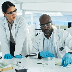 Lab manager and colleague analyzing data in a lab