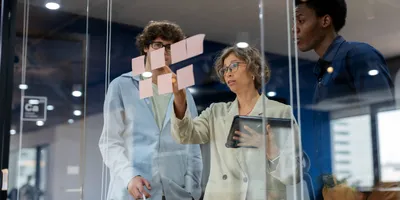 Team discussing a business continuity plan with sticky notes