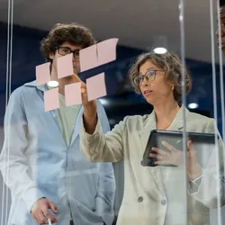 Team discussing a business continuity plan with sticky notes