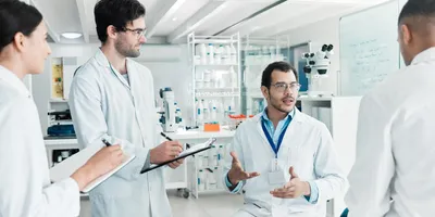 Scientists discussing ideas with active listening in the lab